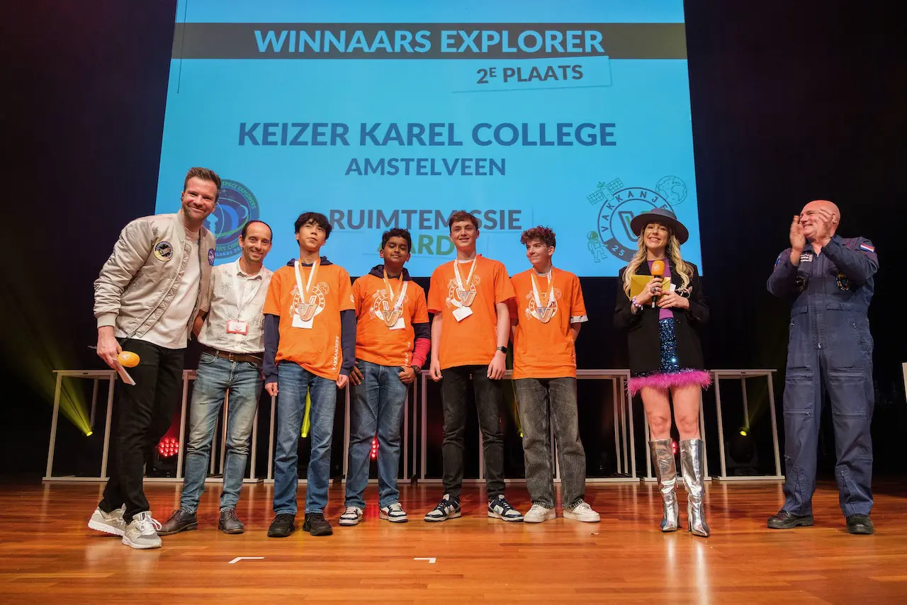 Aerovision Dynamics team celebrating second place with certificate and rocket